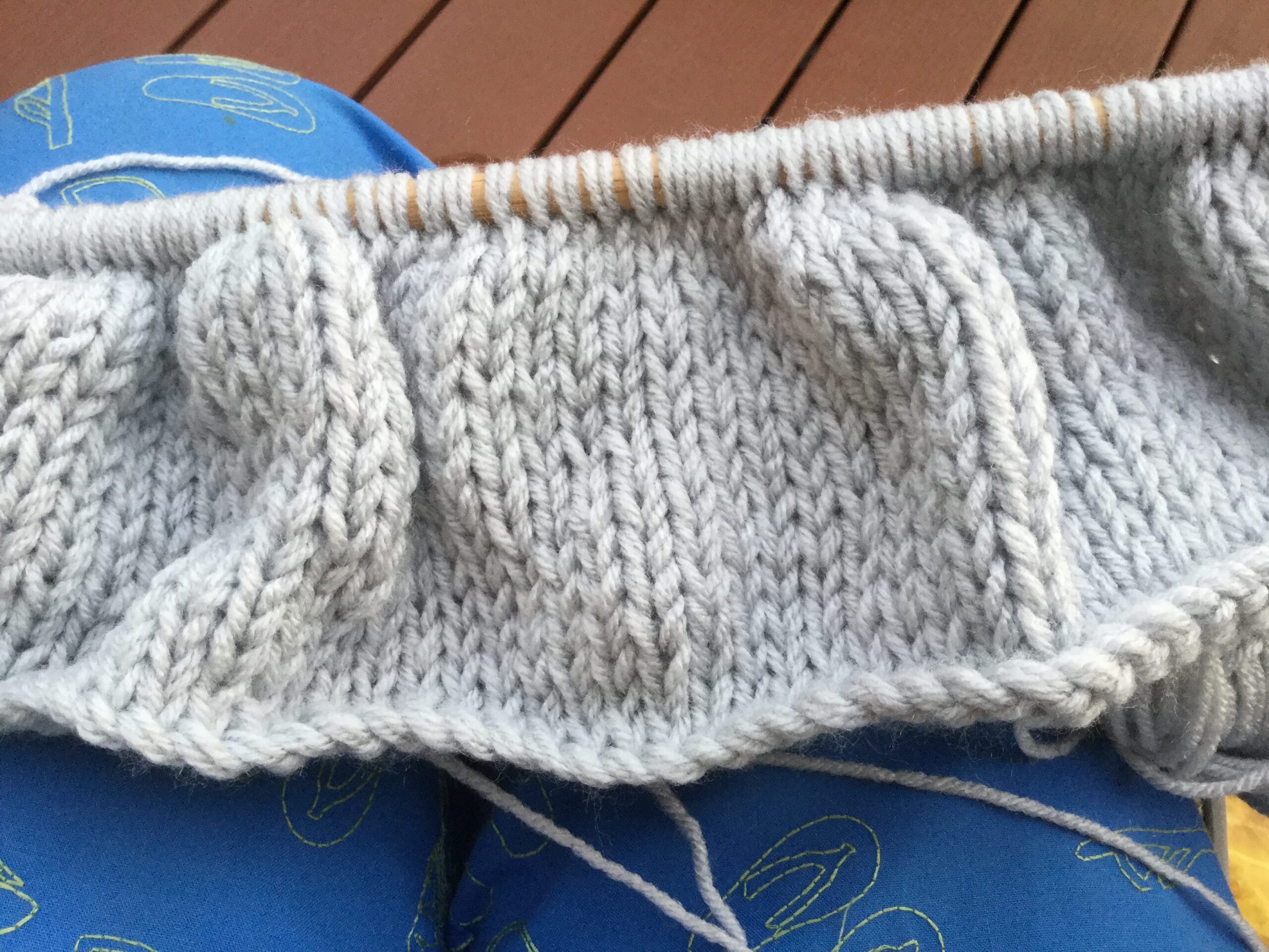 Back of the knit herringbone pillow in clean stocking stitch