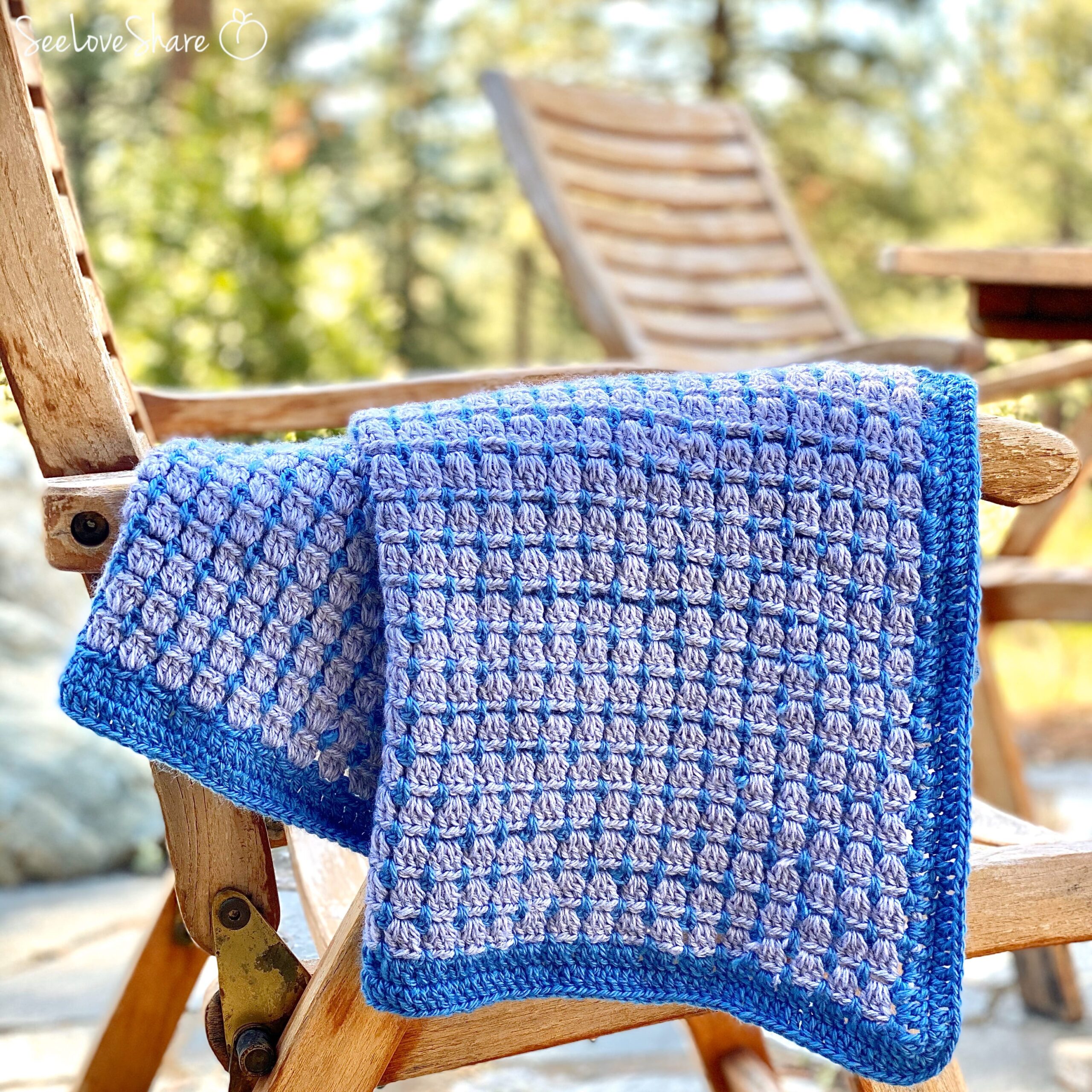 Two-color block stitch blanket crochet pattern in soft blue and cream
