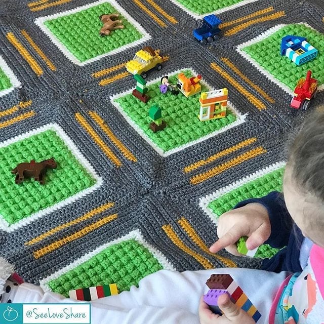 Crochet roadway throw progress shot — winding road design taking shape
