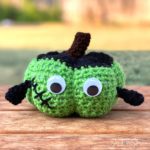 Crochet Frankenstein pumpkin with flat-top hair and bolts