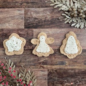 Mini crochet sugar cookie ornament set hanging on a holiday tree