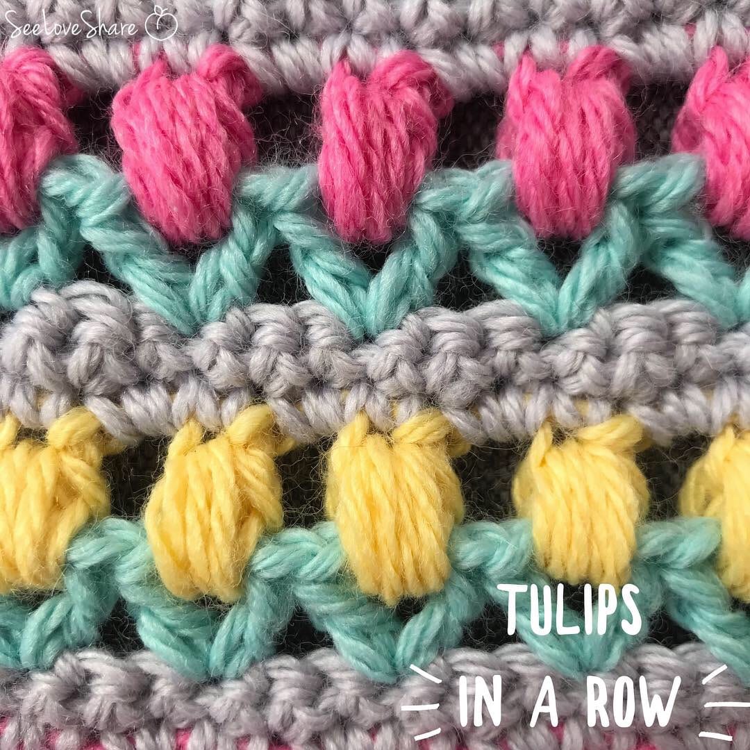 Close-up of tulips in a row crochet stitch showing three-color cluster and shell pattern
