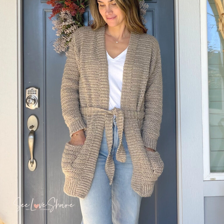 My First Cardi, a beginner crochet cardigan pattern, worn with the optional tie belt